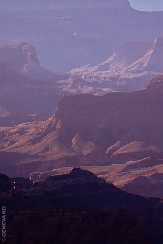 Layered Grand Canyon ridges fading into violet dusk